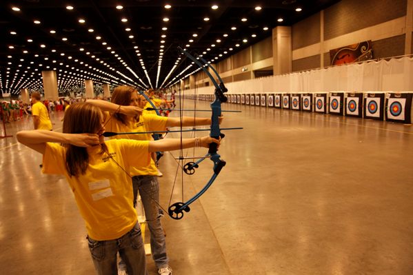 school girls shooting bows